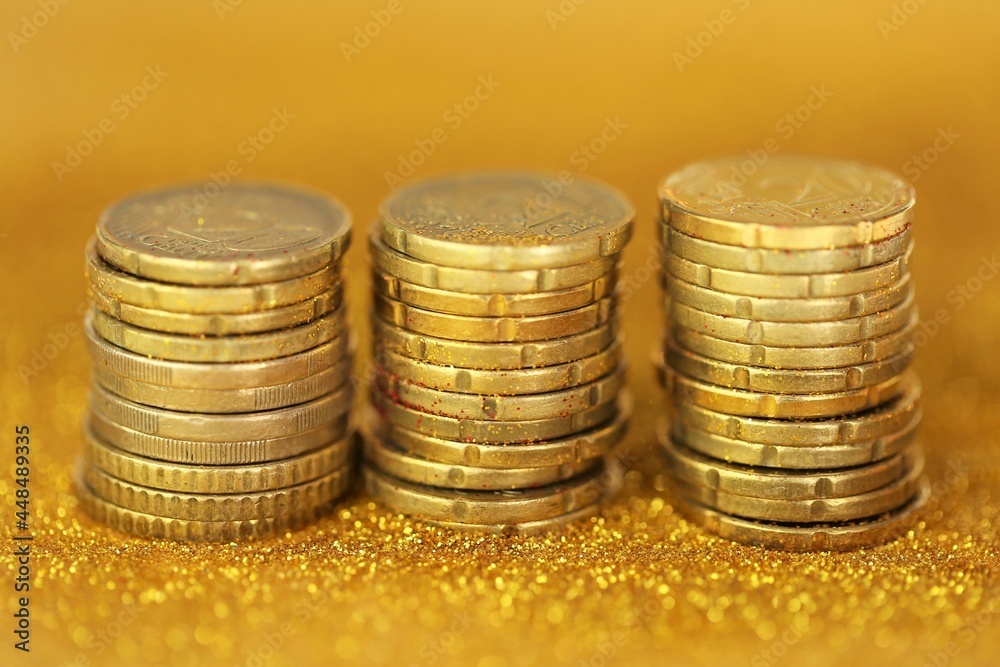 Coins columns in gold glitter .Money and finance. Accumulation and savings symbol Coins columns in gold glitter .Money and finance. Accumulation and savings symbol