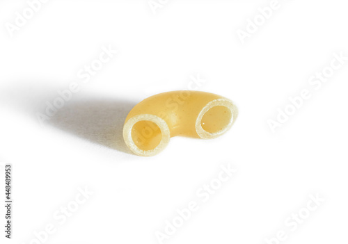 One macaroni isolated on a white background. Macro. Horn