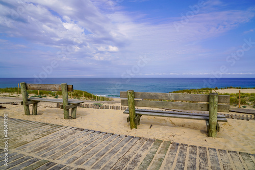 Fototapeta Naklejka Na Ścianę i Meble -  two empty wooden bench on pathway access sandy beach in cap ferret atlantic coast in france