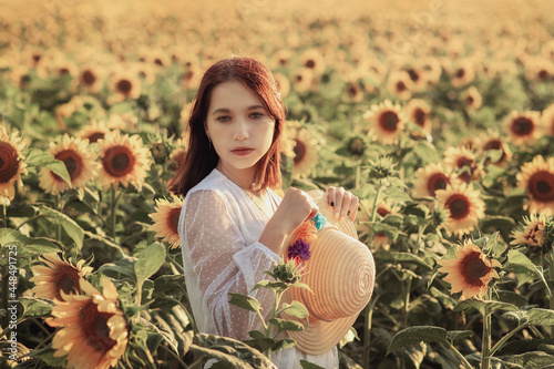 a young girl in a white dress among sunflower flowers