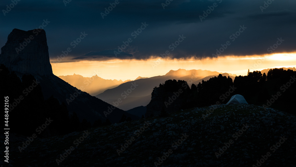 Silhouette of mountains at sunrise with dramatic clouds