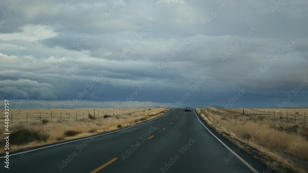 Driving auto, road trip in California, USA, view from car. Hitchhiking traveling in United States. Highway, mountains and cloudy dramatic sky before rain storm. American scenic byway. Passenger POV. Driving auto, road trip in California, USA, view from car. Hitchhiking traveling in United States. Highway, mountains and cloudy dramatic sky before rain storm. American scenic byway. Passenger POV.