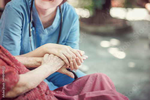 Asian eldery  woman with her caregiver at home. Home care or Elderly care concept.