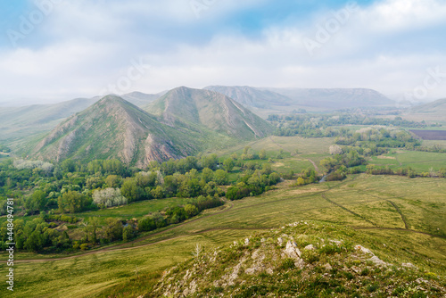 View of the spring mountain landscape through the misty haze. Andreevskie Cones. Photo taken near Andreevka village, Orenburg region, Russia
