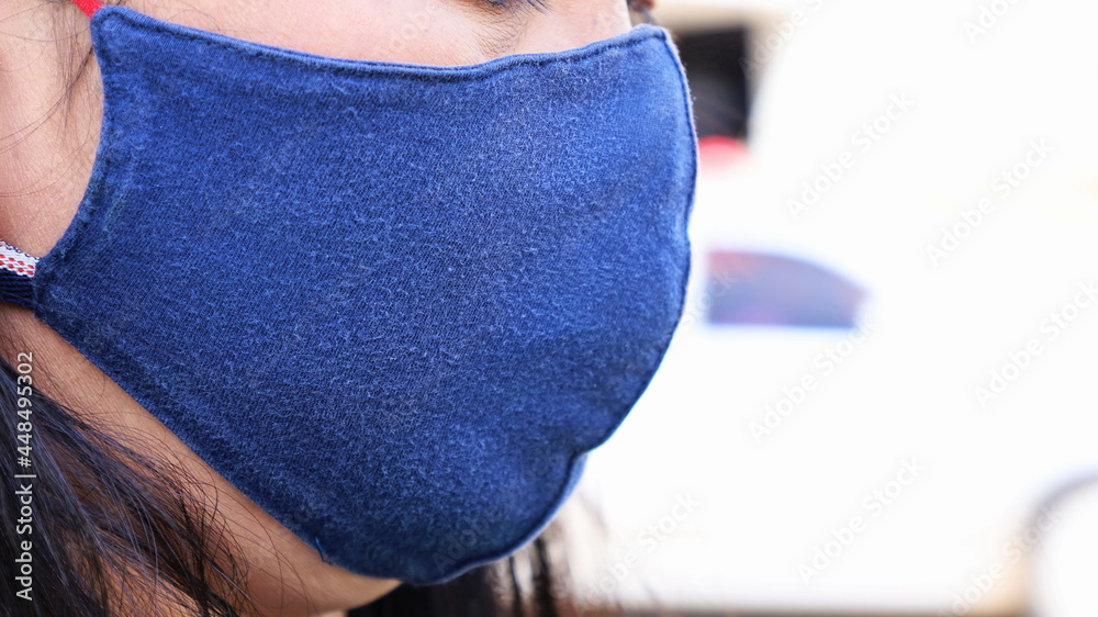© kanin - Women wear cloth masks. Masks made of blue cloth to prevent the global coronavirus pandemic with copy space. Select focus at close range