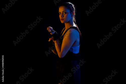 A WOMAN WRESTLER LOOKING AT CAMERA WHILE GETTING READY FOR PRACTISE photo