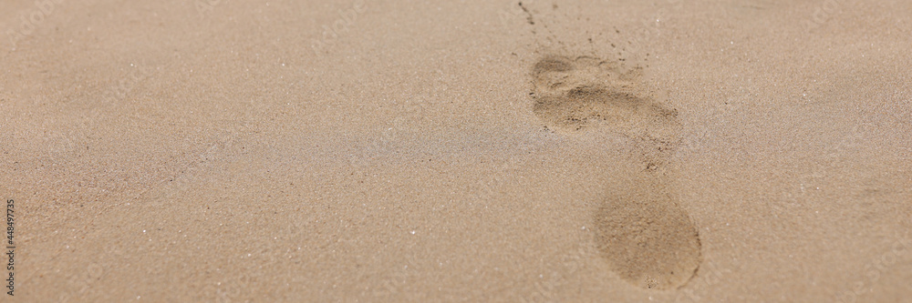Closeup of footprints from bare feet on sand Closeup of footprints from bare feet on sand