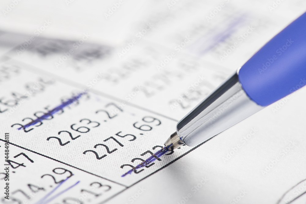 Accounting document with pen, money, coins and checking financial chart. Concept of banking, financial report and financial audit. Accounting document with pen, money, coins and checking financial chart. Concept of banking, financial report and financial audit.