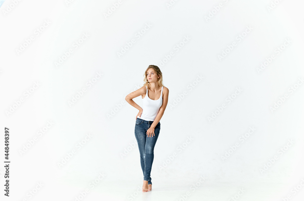 pretty woman in jeans movements dance barefoot light background pretty woman in jeans movements dance barefoot light background