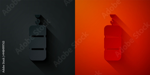 Paper cut Punching bag icon isolated on black and red background. Paper art style. Vector