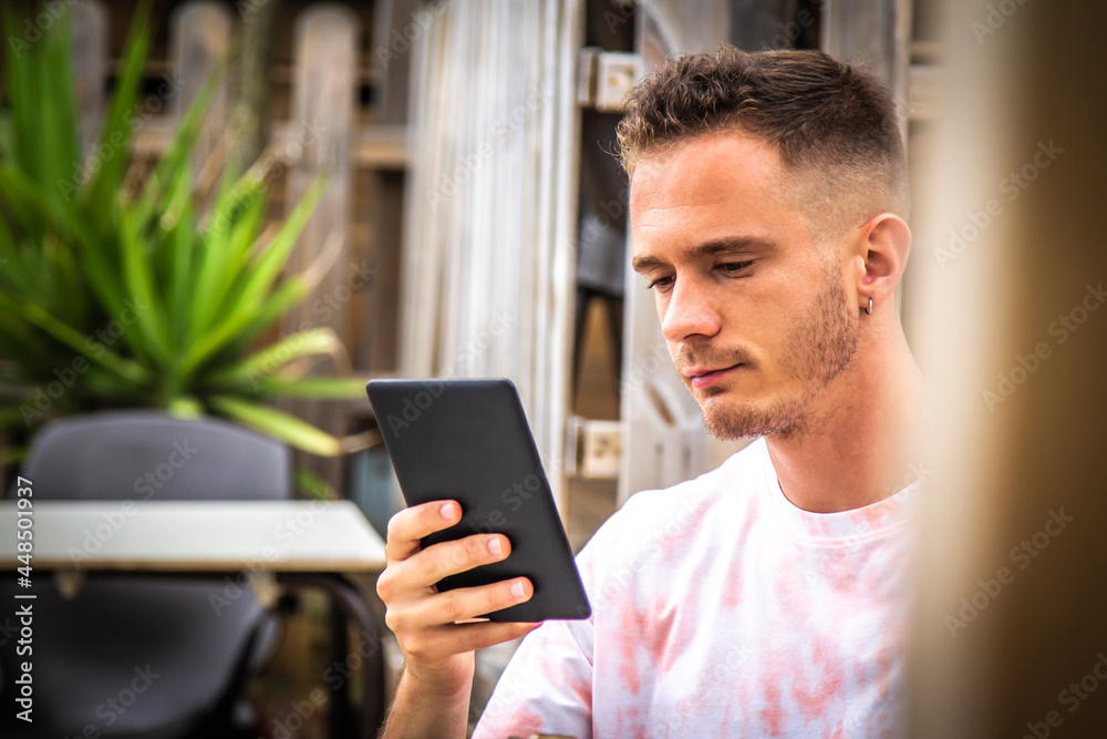 man with digital tablet or ebook in outdoor cafe man with digital tablet or ebook in outdoor cafe