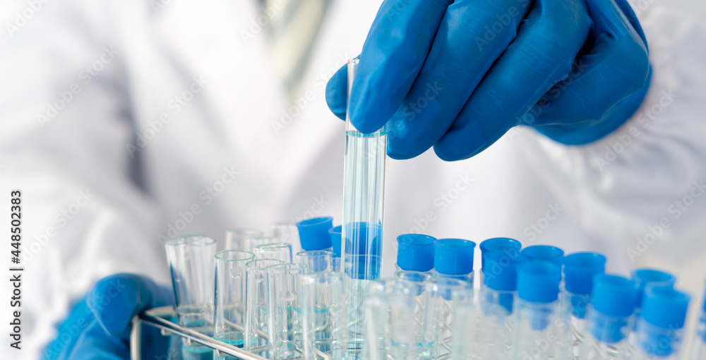 Doctor holding test tube with sample for analysis in laboratory, closeup Doctor holding test tube with sample for analysis in laboratory, closeup
