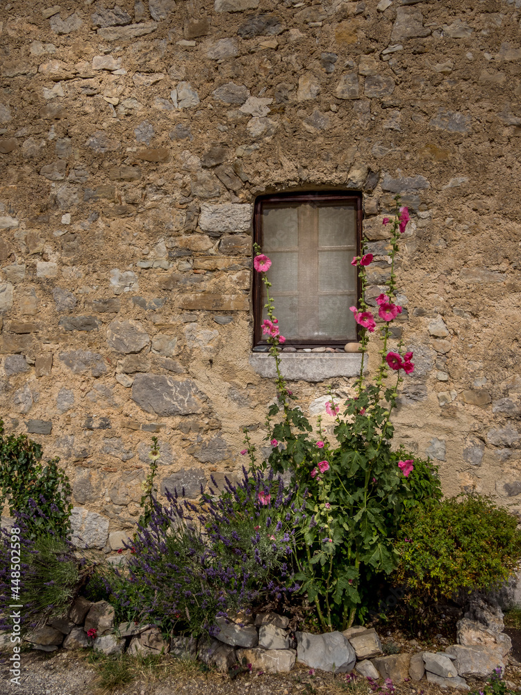 Small window of an old stone house in Provence
