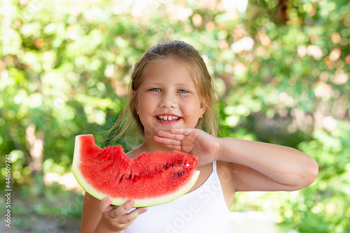 Cute child girl eats watermelon. Selective focus.