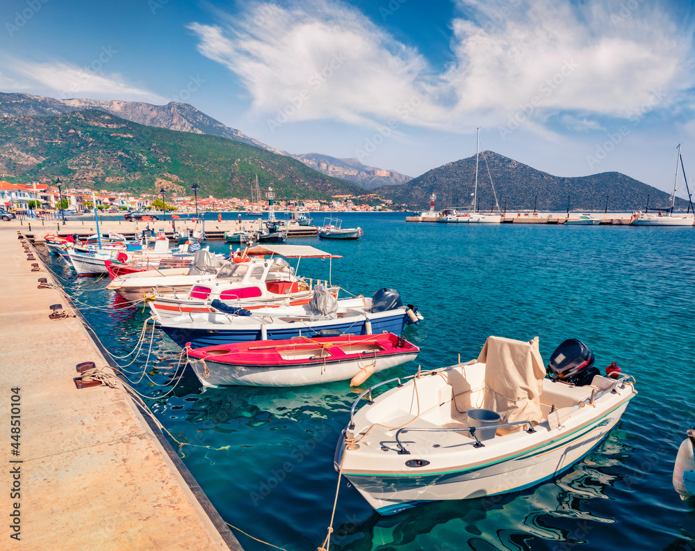 Fishing boats in Tyros port, tourist and old naval town in Arcadia. Sunny morning seascape of Myrtoan sea, Peloponnese peninsula, Greece, Europe. Traveling concept background..
