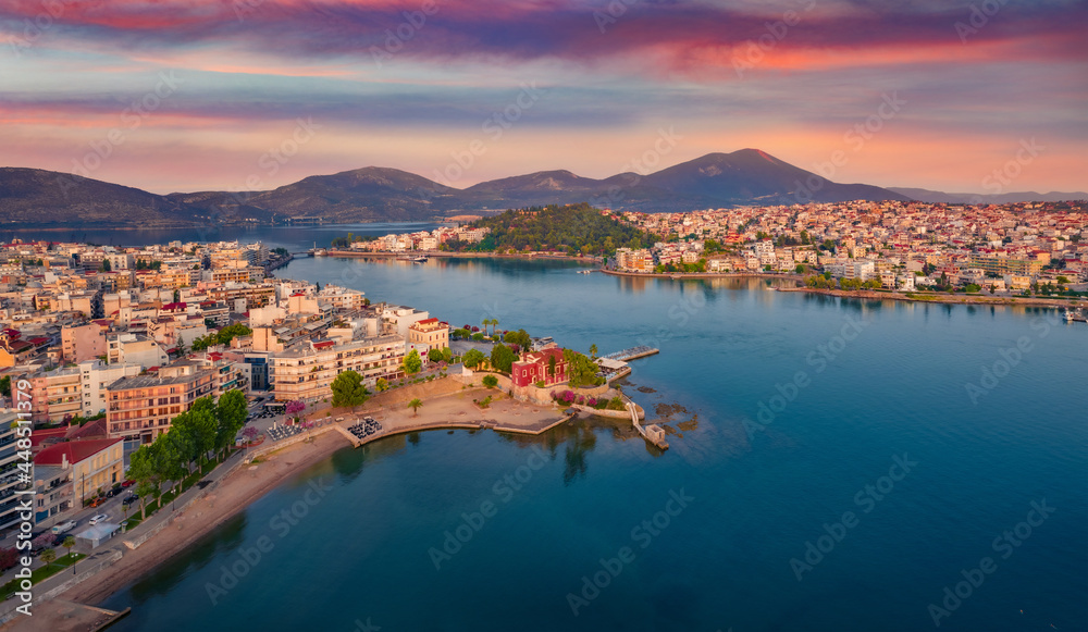 Great sunrise in Chalcis town. Stunning morning seascape of Aegean sea, North Euboean Gulf. Impressive summer scene of Euboea island, Greece, Europe. Traveling concept background..