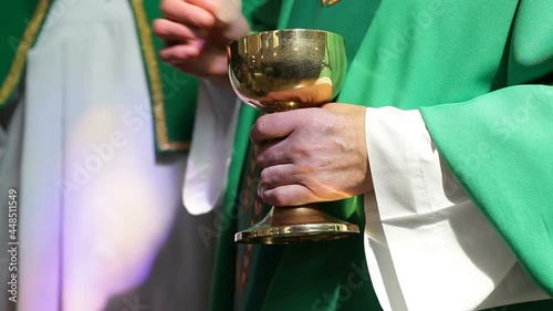 A Catholic priest distributes a prosphora from a bowl to believing parishioners. Liturgical liturgical bread used in Orthodoxy for the sacrament of the Eucharist.priest gives altar breads. photo