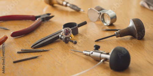 Various jeweler tools on the wooden table