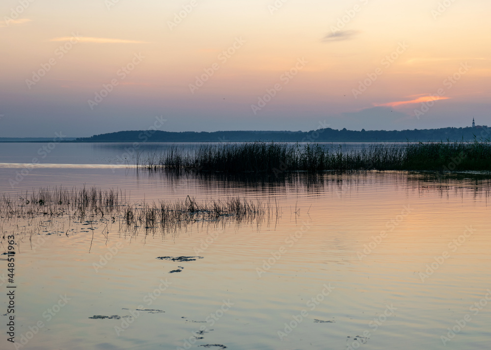 summer landscape on the shore of the lake at dawn, colors in the sky before sunrise, Lake Burtnieki, Latvia