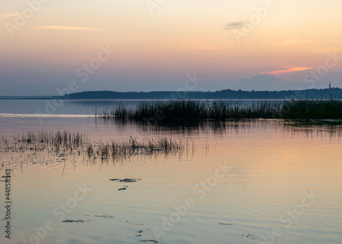Fototapeta Naklejka Na Ścianę i Meble -  summer landscape on the shore of the lake at dawn, colors in the sky before sunrise, Lake Burtnieki, Latvia