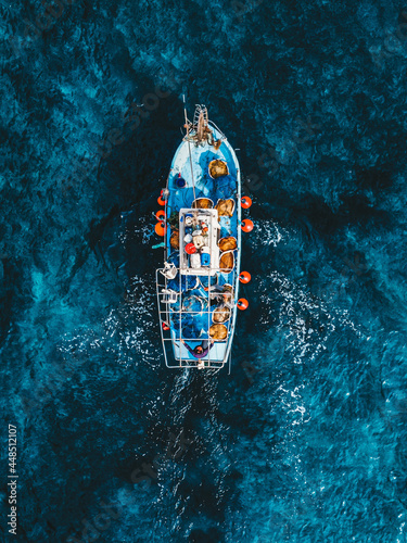 Leinwand Poster Top view drone aerial photo of fisher boat sailing Cyprus Mediterranean Sea