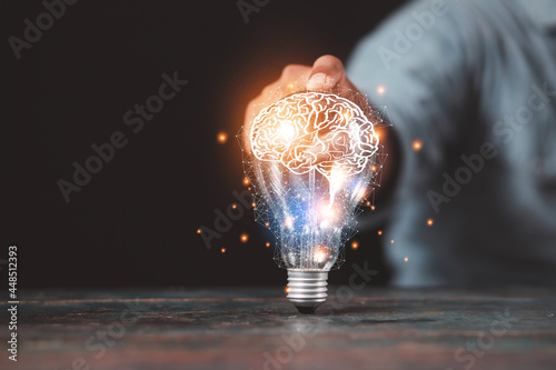 Tableau sur toile businessman holding light bulb and brain graphic inside It represents the imagination of business networking technology innovation