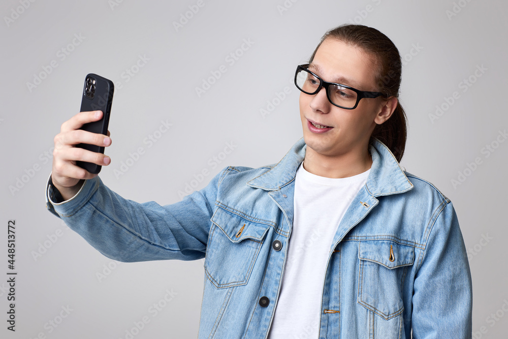 man in glasses and jeans jacket making selfie man in glasses and jeans jacket making selfie