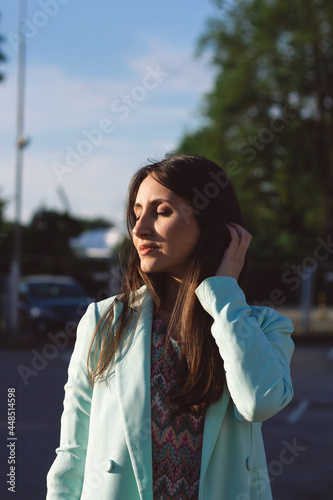 Portrait of a young beautiful caucasian woman enjoying the sun during golden hour