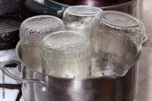 Photography Glass jars in pot during steam sterilization for home canning