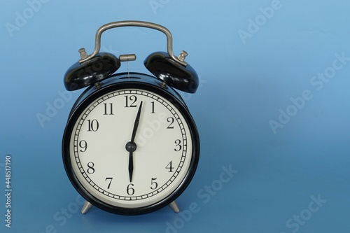 alarm clock isolated on blue background