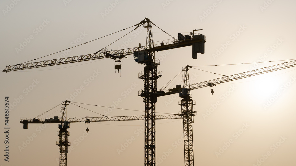 Tower crane at building construction site silhouette.