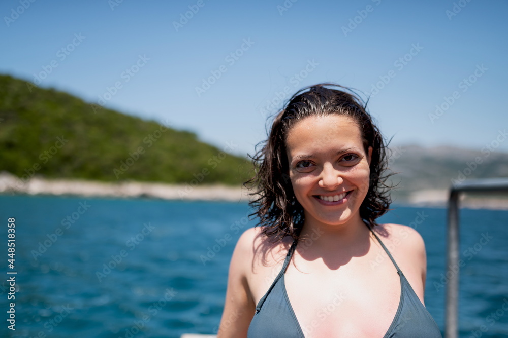 Beautiful woman in green bikini on tropical beach. Portrait of happy young woman smiling at sea. Brunette tanned girl in swimwear enjoying on beach. Beautiful woman in green bikini on tropical beach. Portrait of happy young woman smiling at sea. Brunette tanned girl in swimwear enjoying on beach.
