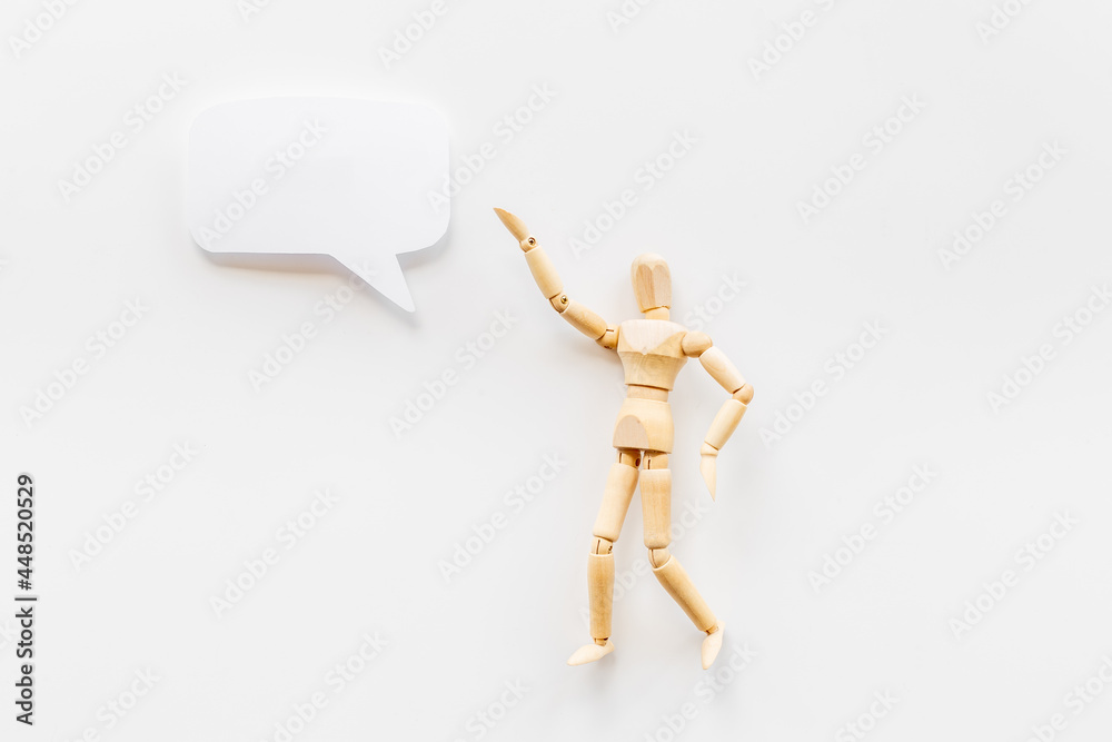 Wooden man figure presenting and showing on speech bubble banner Wooden man figure presenting and showing on speech bubble banner