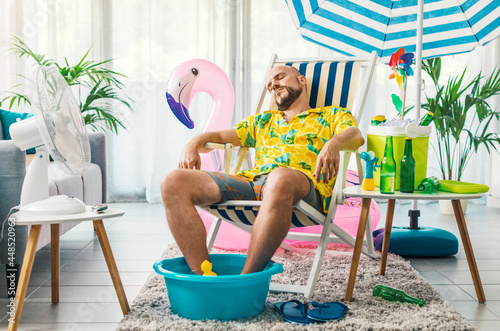 Man having a staycation and resting on a deckchair at home photo