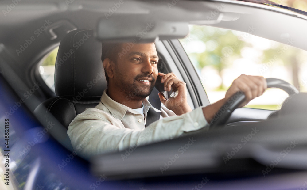 transport, communication and people concept - smiling indian man or driver driving car and calling on smartphone transport, communication and people concept - smiling indian man or driver driving car and calling on smartphone