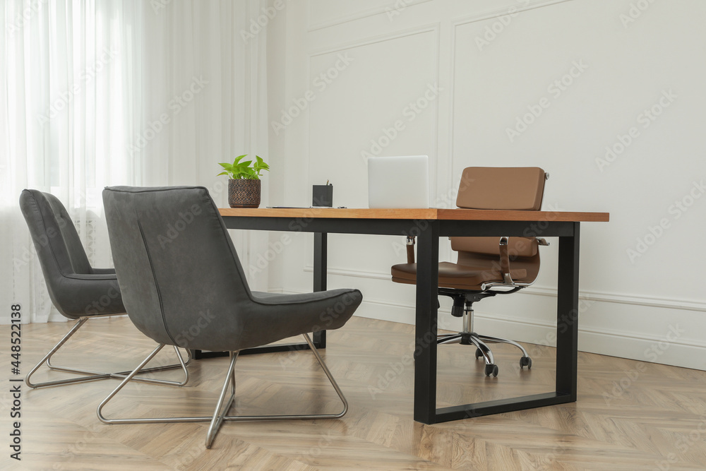Director's office with large wooden table and comfortable armchairs. Interior design Director's office with large wooden table and comfortable armchairs. Interior design