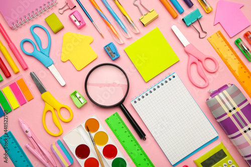 School supplies on pink background with copy space. Back to school concept.