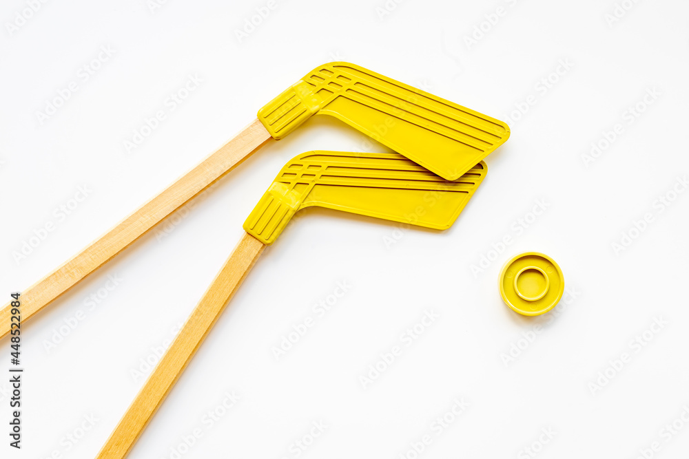 Competitive sports equipment with hockey sticks and puck. Top view Competitive sports equipment with hockey sticks and puck. Top view