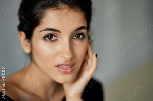 pretty brunette in black dress cosmetics luxury