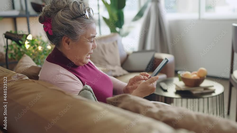 old senior asian grandmother sit casual relax hand use smartphone technology device video call to have greeting and conversation with her family white home isolation quarantine period moment old senior asian grandmother sit casual relax hand use smartphone technology device video call to have greeting and conversation with her family white home isolation quarantine period moment