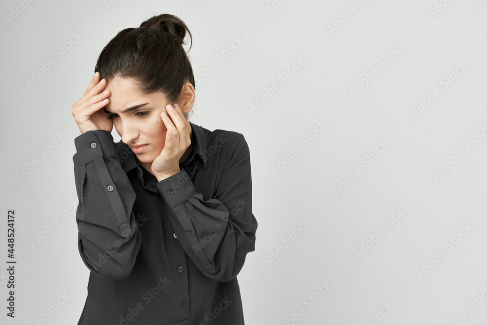 woman in black shirt holding her head pain problems emotions stress woman in black shirt holding her head pain problems emotions stress