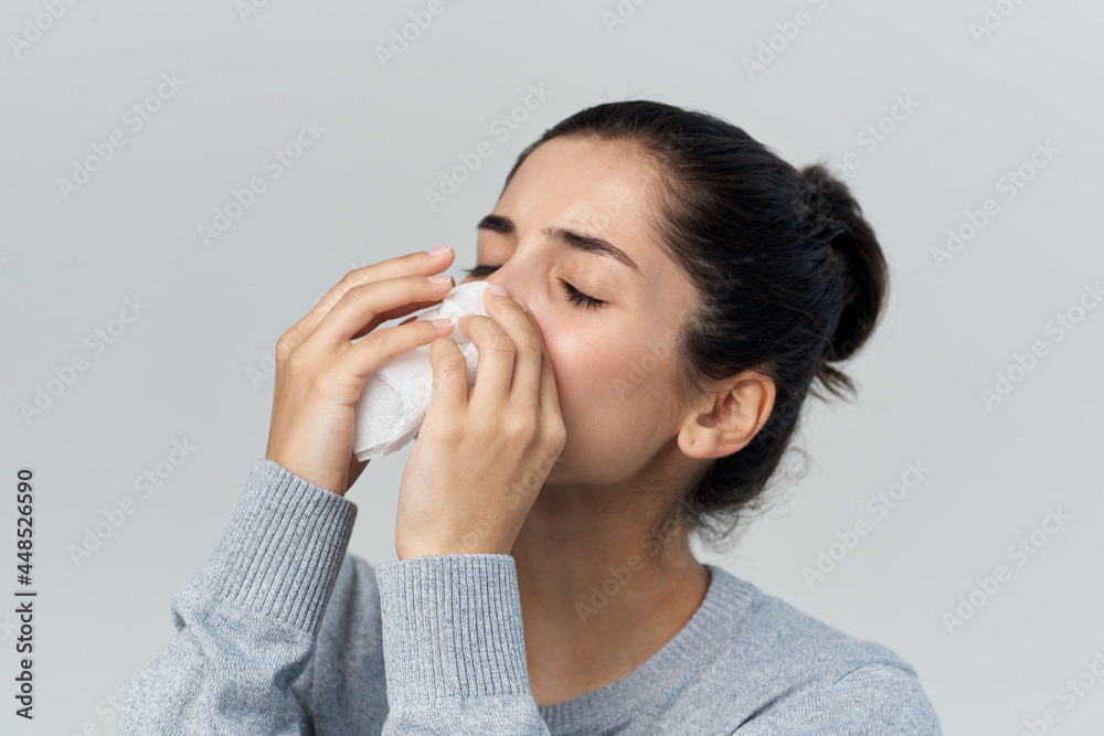 brunette wipes her nose with a handkerchief runny nose unhealthy look brunette wipes her nose with a handkerchief runny nose unhealthy look