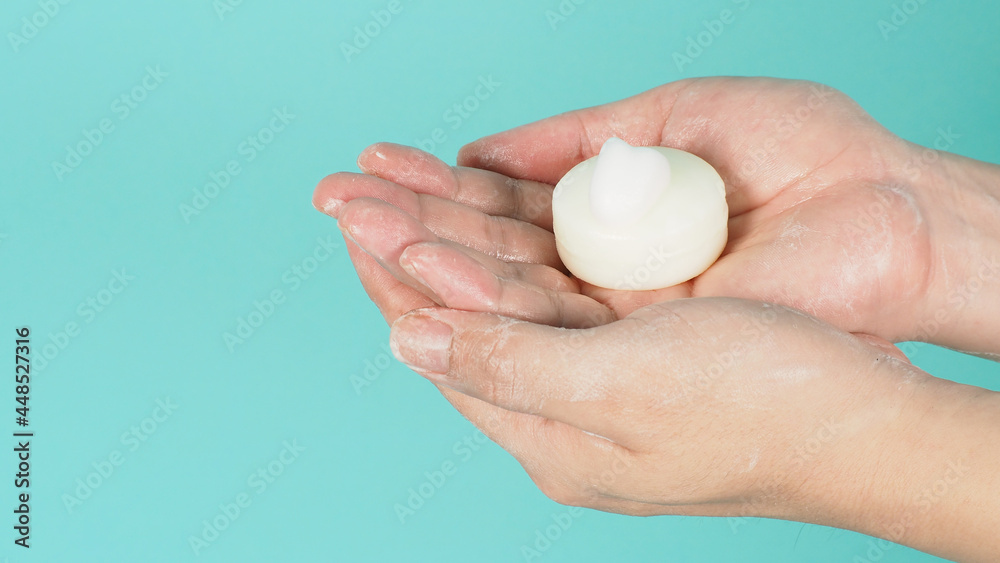 Hands washing gesture with Bar soap and bubble on mint green or Tiffany Blue background. Hands washing gesture with Bar soap and bubble on mint green or Tiffany Blue background.