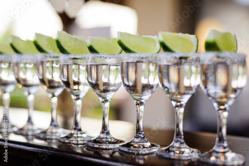 Shots of tequila with a slice of lime on the party