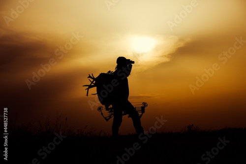 Silhouette of a bow hunter