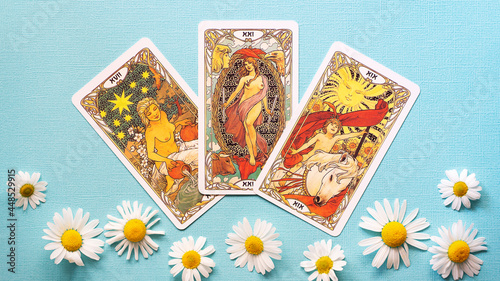 Obraz na plátne Golden tarot cards on the Blue background with Daisy flowers, Star, sun, peace