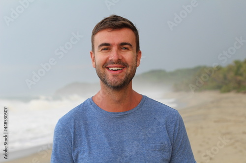 Healthy guy smiling at the beach