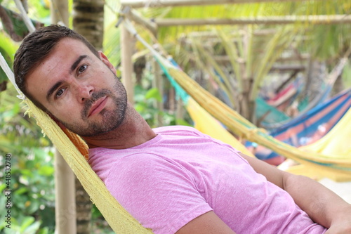 Guy enjoying a hammock in topical island
