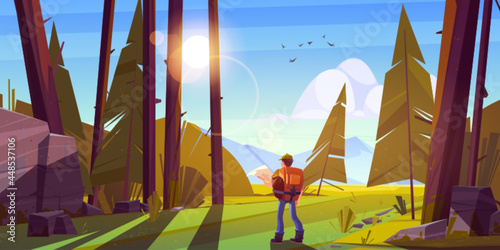 Hiker man in forest with mountains on horizon