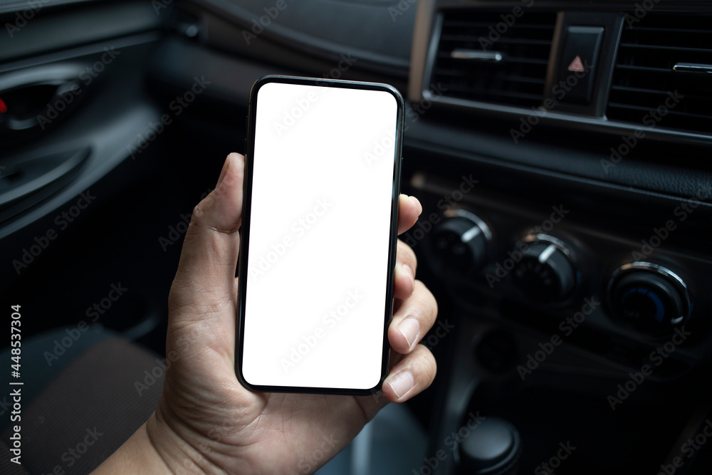 Man hand holding  smartphone with blank screen in the supercar.